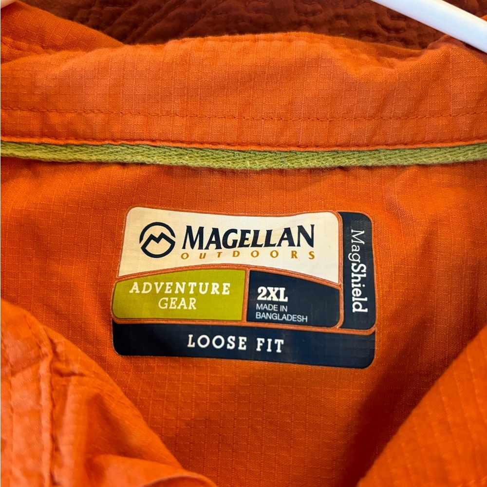 Used Magellan 2XL button up shirt. Orange in color.